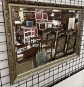 A large gilt rectangular wall mirror