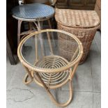 A wicker laundry basket together with a circular side table and a circular coffee table