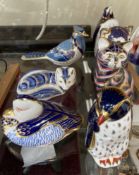Seven Royal Crown Derby paperweights, including a cat, penguins, a koala,