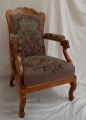 A Biedermeier style burr veneered library chair with a shaped back above scrolling arms and shaped