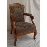 A Biedermeier style burr veneered library chair with a shaped back above scrolling arms and shaped