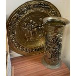 A stamped brass wall plaque and a similar umbrella stand