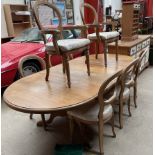 A modern pine extending dining table together with eight balloon back dining chairs a sideboard and