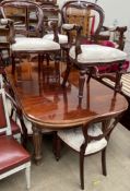 A reproduction mahogany dining suite comprising an extending dining table and ten chairs,