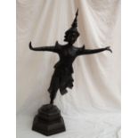 A large bronze figure of a Taiwanese dancer, standing on one leg with arms outstretched ,
