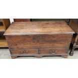 An 18th century coffer, with a planked top and two drawers on bracket feet,