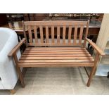 A modern teak garden bench