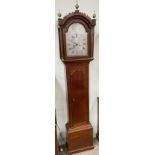 A 19th century oak longcase clock, with an arched hood and ionic columns and a long trunk door,