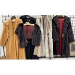 A fur stole together with two fake fur coats,