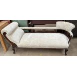 An Edwardian cream upholstered chaise longue