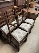 An oak gateleg dining table together with a set of six ladder back dining chairs