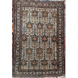 A Persian rug with a cream ground decorated with multiple vases of flowers 101 x 147cm