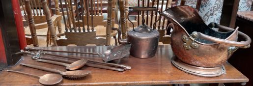 A copper helmet shaped coal scuttle together with a copper kettle,