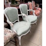 A pair of grey painted French elbow chairs together with a white painted pair