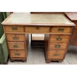 An Edwardian mahogany campaign style desk,