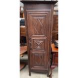 A French oak hall robe with a carved panel door on turned legs,