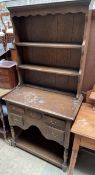 A 20th century oak dresser of small size, with a moulded cornice and two shelves,