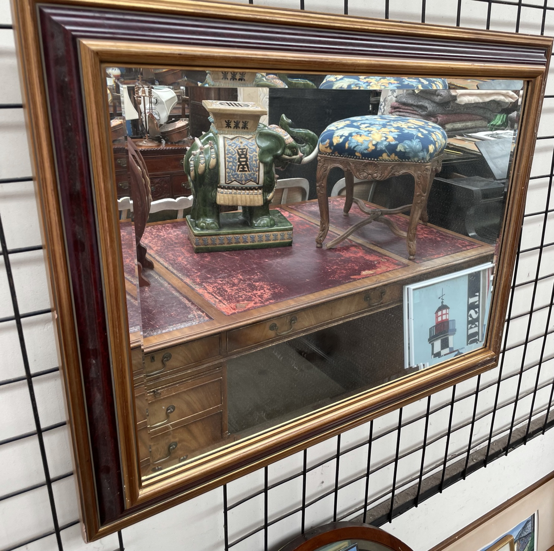 A gilt cushion framed wall mirror