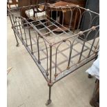 A child's cot with arched metal work frame