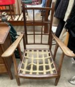 An early 20th century reclining chair with a lattice back