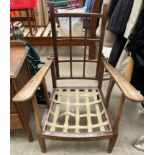 An early 20th century reclining chair with a lattice back