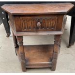 A 20th century oak side table with a frieze drawer on turned legs united by an undertier