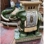 A Chinese pottery garden seat in the form of an elephant with trunk raised
