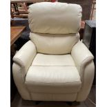 A cream leather electric recliner chair