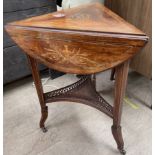 A Victorian inlaid rosewood table of triangular shape with drop flaps on three legs united by an