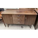 A mid 20th century dark teak sideboard, bears a trade label for Sutcliffe,