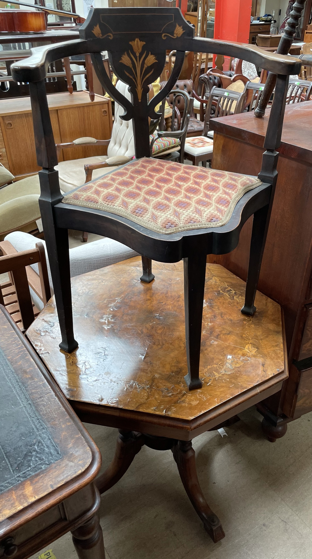 An Edwardian cornet chair with a floral inlaid back,