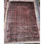 A large red ground Turkoman rug, signed,