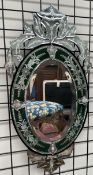 A Murano mirror with etched decoration and a green border,