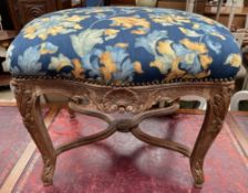 A continental stool with a pad upholstered seat,