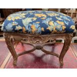 A continental stool with a pad upholstered seat,