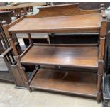 A Victorian oak three tier buffet with ring turned uprights