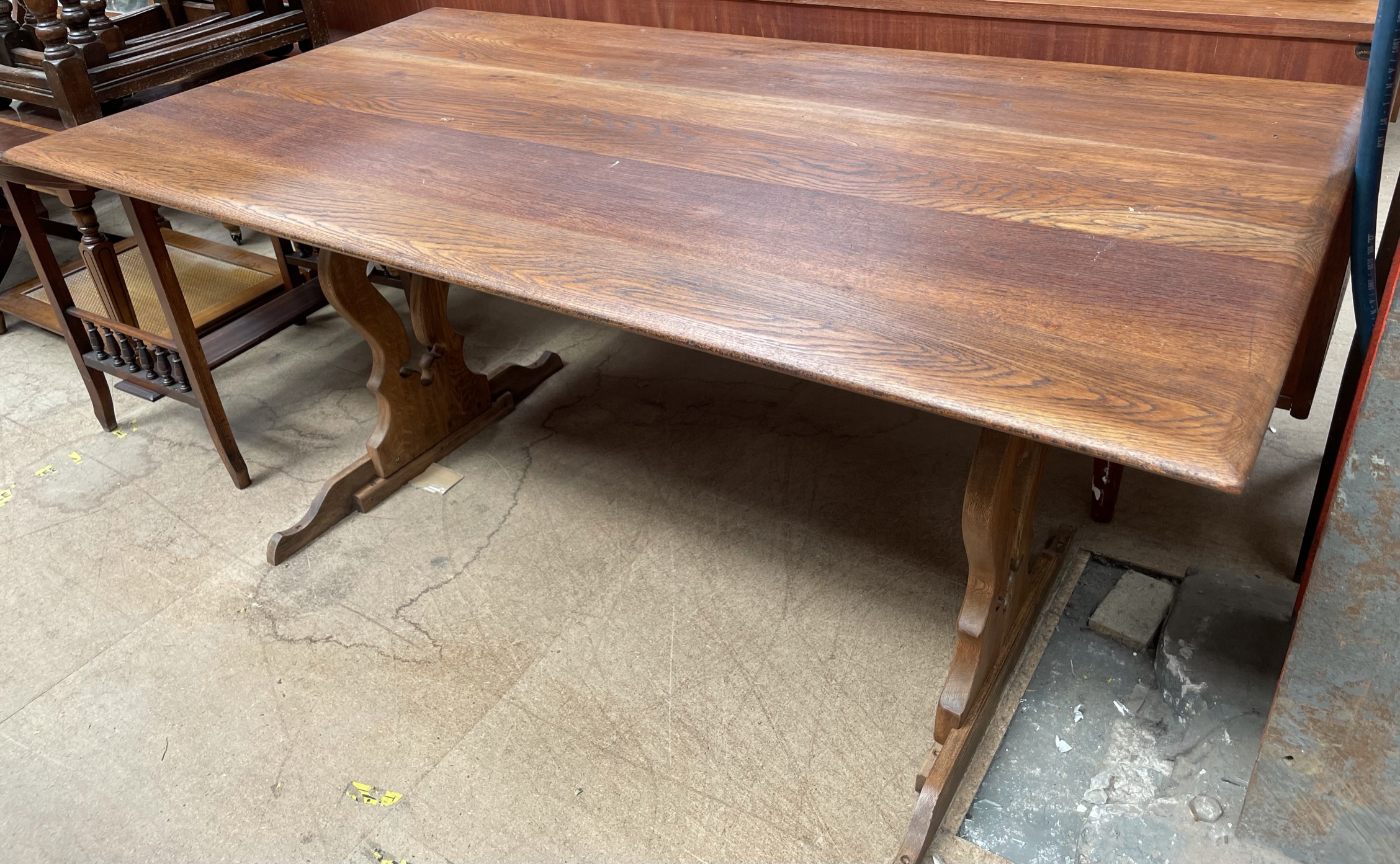 A 20th century oak refectory table with a rectangular top on pierced ends,