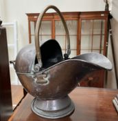 A copper helmet shaped coal scuttle