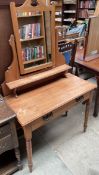 A satin walnut dressing table with a frieze drawer on turned legs