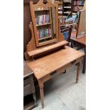 A satin walnut dressing table with a frieze drawer on turned legs