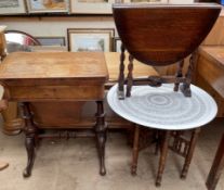 A Victorian walnut work / games table with a foldover top above a frieze drawer and well on turned