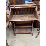 An early 20th century oak desk, with a tambour front,