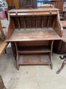 An early 20th century oak desk, with a tambour front,