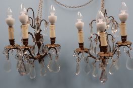 A pair of gilt metal three branch lustre drop wall lights,