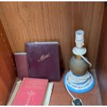 A porcelain table lamp together with schoolboy Autograph albums etc