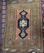 A yellow ground rug, with a central geometric medallion and multiple guard stripes,