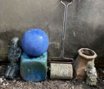 A garden roller together with a ceramic cube and ball,