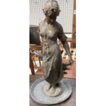 A gilt metal statute of a maiden