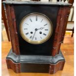 A black slate mantle clock, with an enamel dial and Roman numerals,