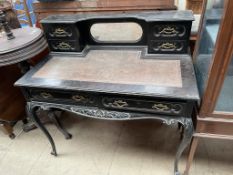 A late Victorian ebonised lady's writing desk, the raised back with a mirror and drawers,